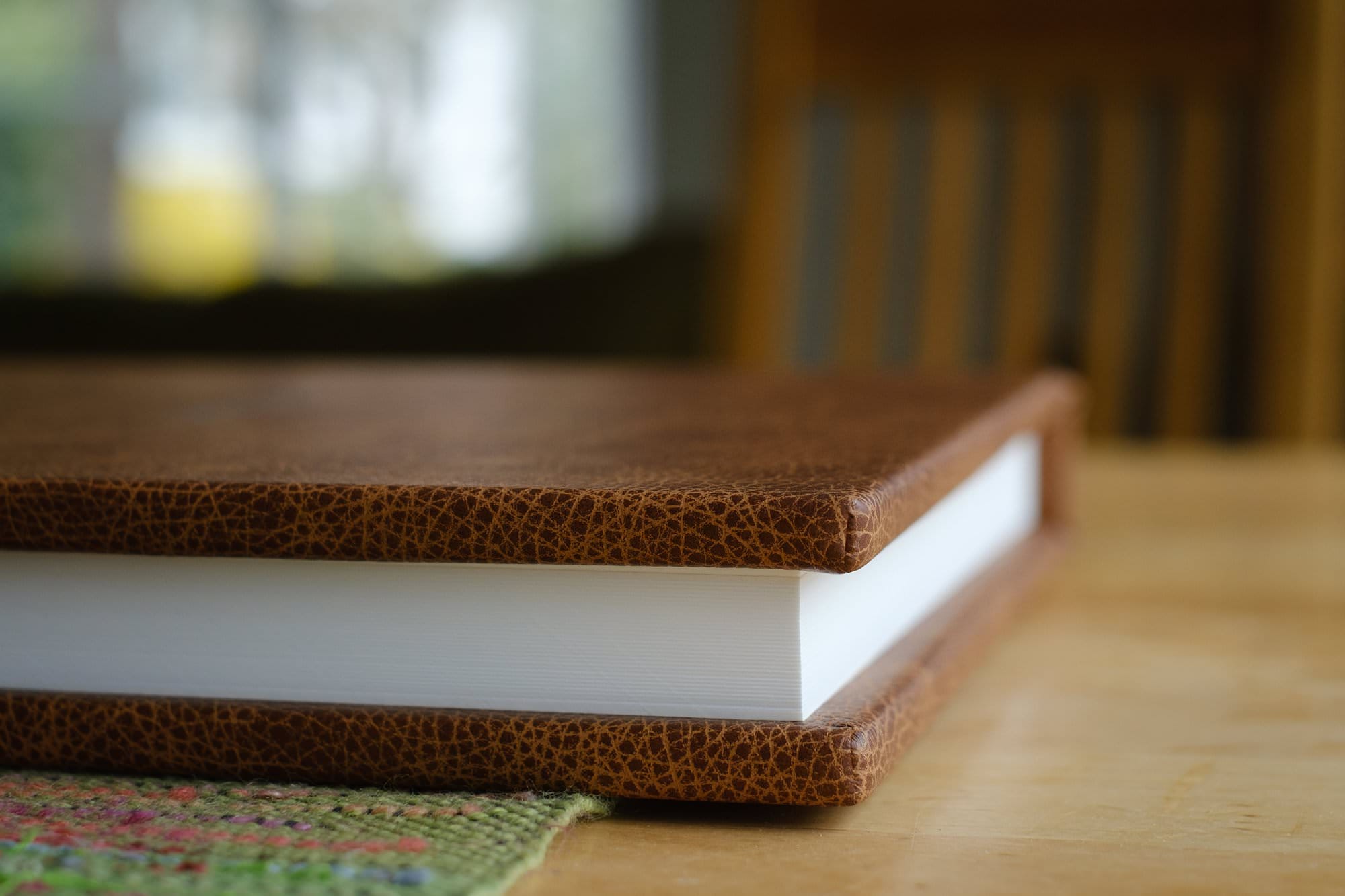 side shot of a brown leather-bound fine art wedding photography album