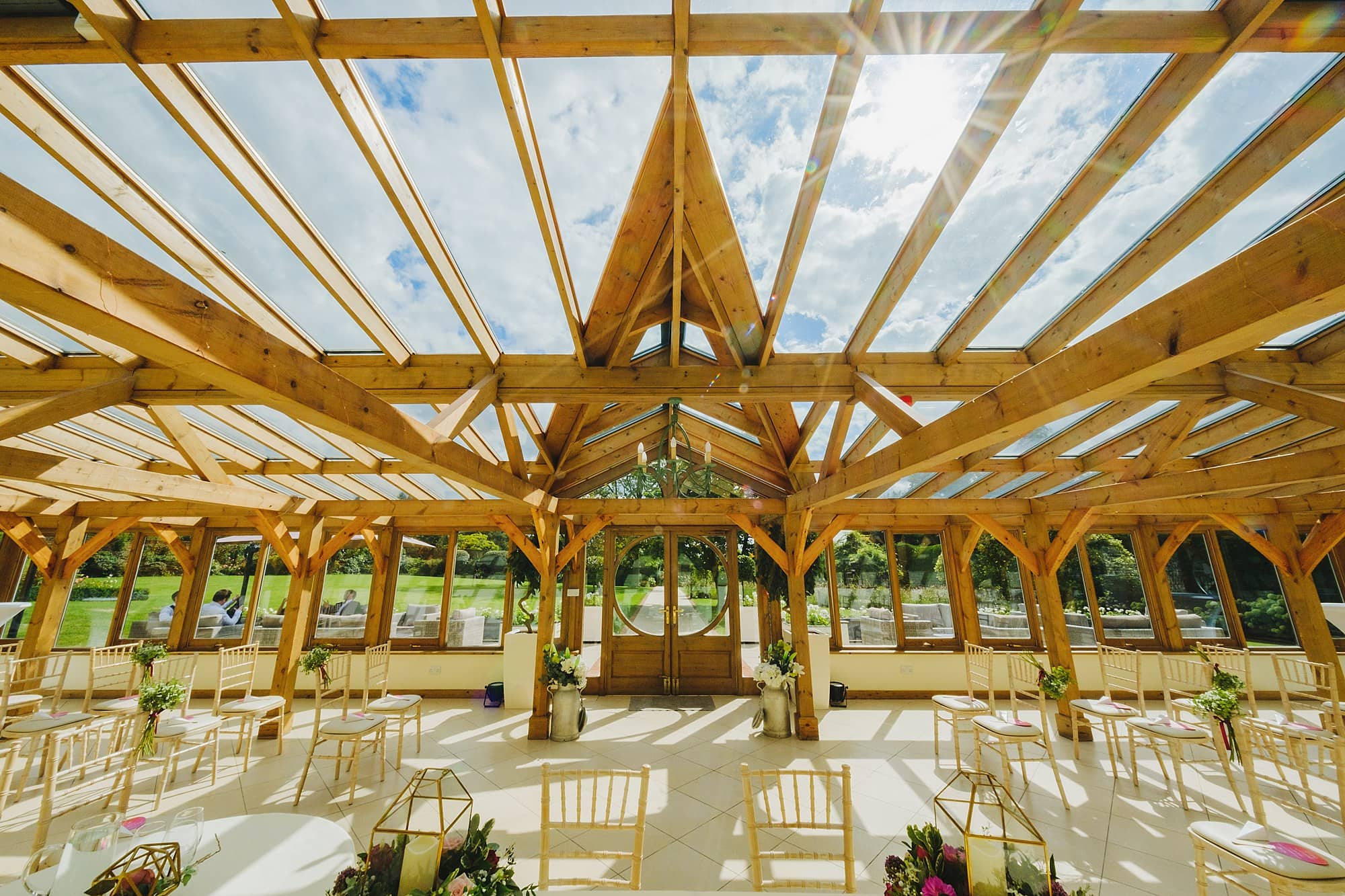 gaynes park wedding photographer Owen Billcliffe captured this wide shot of the orangery in the sun, ready for a wedding ceremony