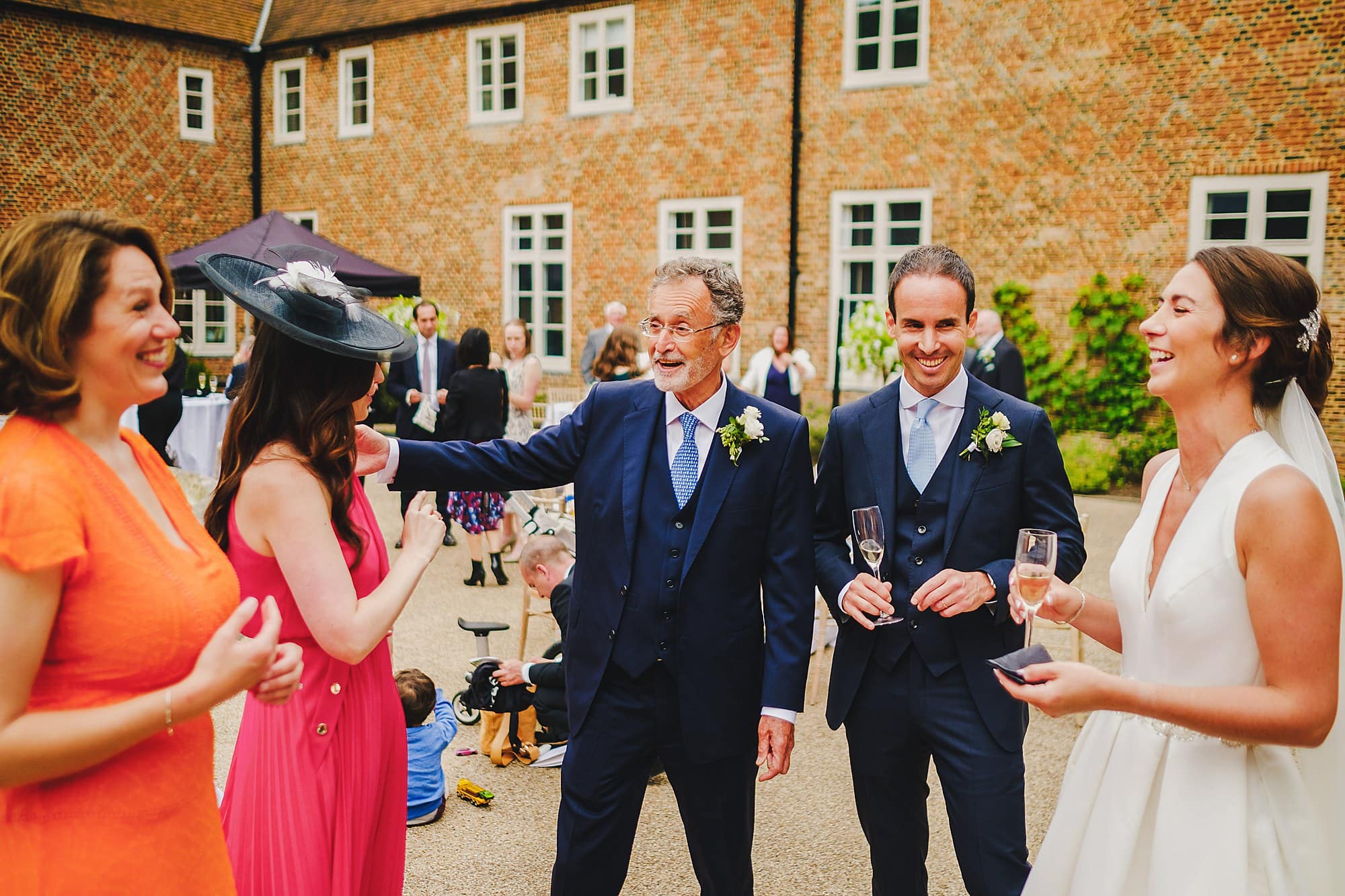 the bride and groom and guests at Fulham Palace London, by wedding photographer Owen Billcliffe